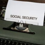 Close-up of a vintage typewriter typing 'SOCIAL SECURITY' on paper, classic concept.