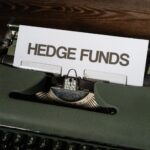 Close-up of a vintage typewriter with a paper labeled 'Hedge Funds'.