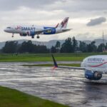 JetSmart and AeroMexico aircraft on runway under cloudy sky, showcasing aviation travel.