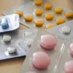 Close-up view of assorted colorful medication blister packs with diverse pills.
