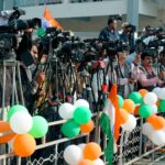 Journalists and videographers gather with cameras in Ahmedabad, capturing a vibrant scene.