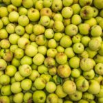 Top view of a large collection of fresh green apples, perfect for food and agriculture themes.