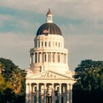 Captivating view of the California State Capitol amidst lush greenery under a clear sky.