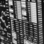 Monochrome image of stock market data on a screen, depicting financial information and trends.