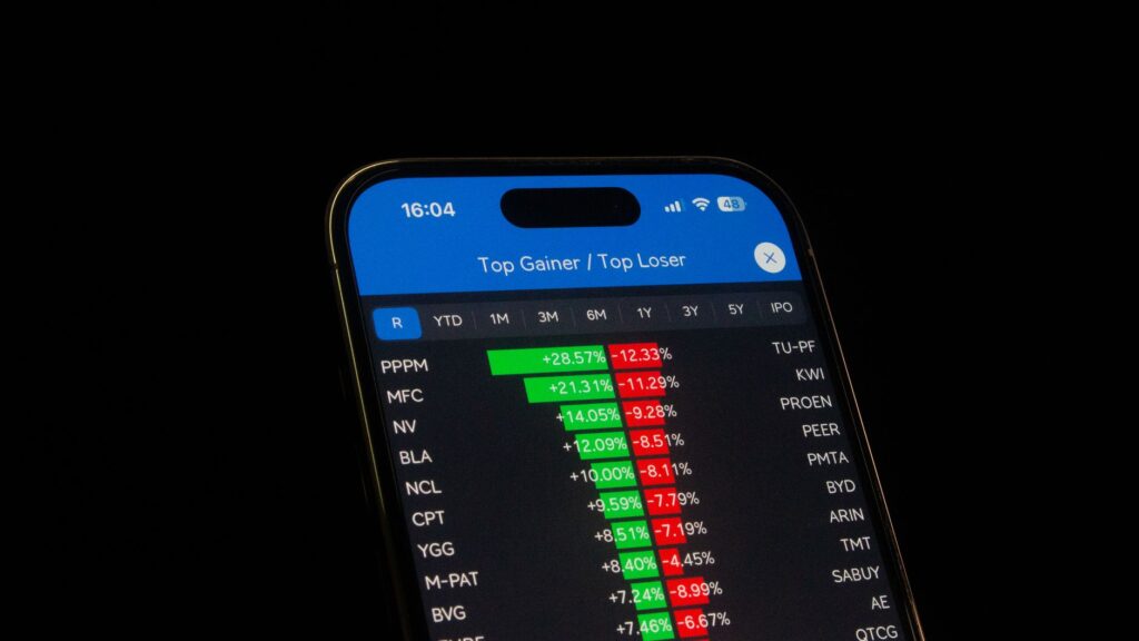 Close-up of a smartphone showing stock performance in a trading app. Ideal for financial and business themes.
