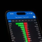 Close-up of a smartphone showing stock performance in a trading app. Ideal for financial and business themes.