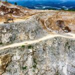 Aerial view of a quarry with heavy machinery in Purwakarta, West Java, Indonesia.