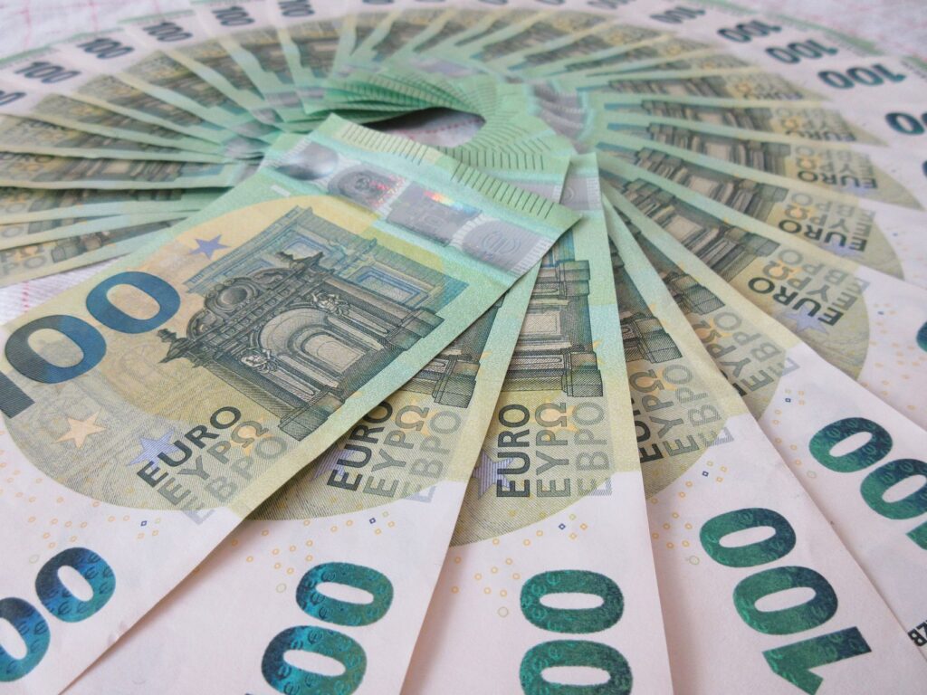 Close-up of fan spread 100 Euro banknotes, showcasing wealth and finance theme.