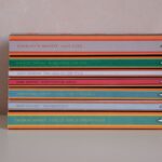 A neatly stacked collection of classic literature books on a plain background, perfect for bookworms.