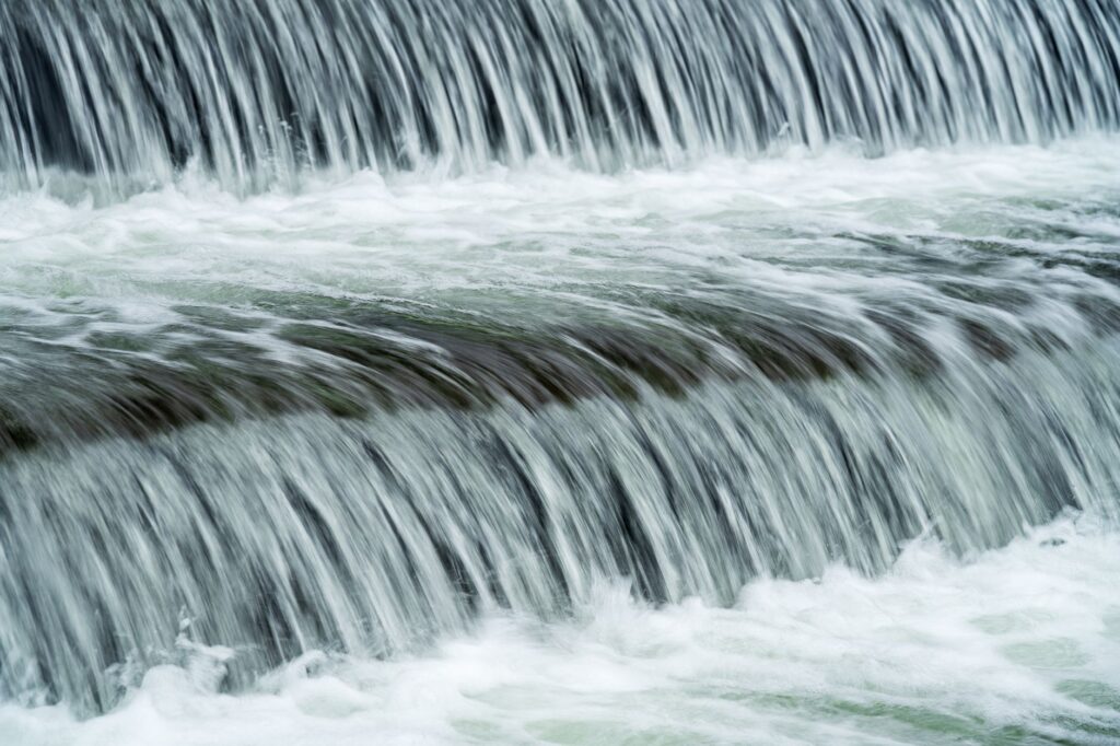 Close-up of cascading waterfall in Myślenice, Poland, capturing the serene flow of water.
