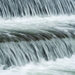 Close-up of cascading waterfall in Myślenice, Poland, capturing the serene flow of water.