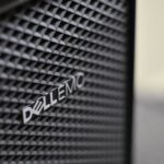 Detailed close-up of Dell EMC server logo on hardware grill with shallow focus and textured patterns.