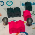 Abstract representation of real estate market analysis with model houses and charts.