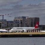 View of British Airways and Helvetic Airways planes at London City Airport.