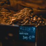 A rustic bundle of Weizen wheat on display in a market setting, prices marked in German.