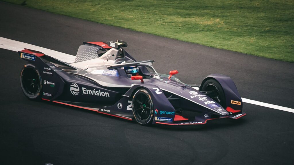 Dynamic image of a Formula E car racing on the tracks in Mexico City, showcasing speed and technology.