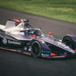 Dynamic image of a Formula E car racing on the tracks in Mexico City, showcasing speed and technology.