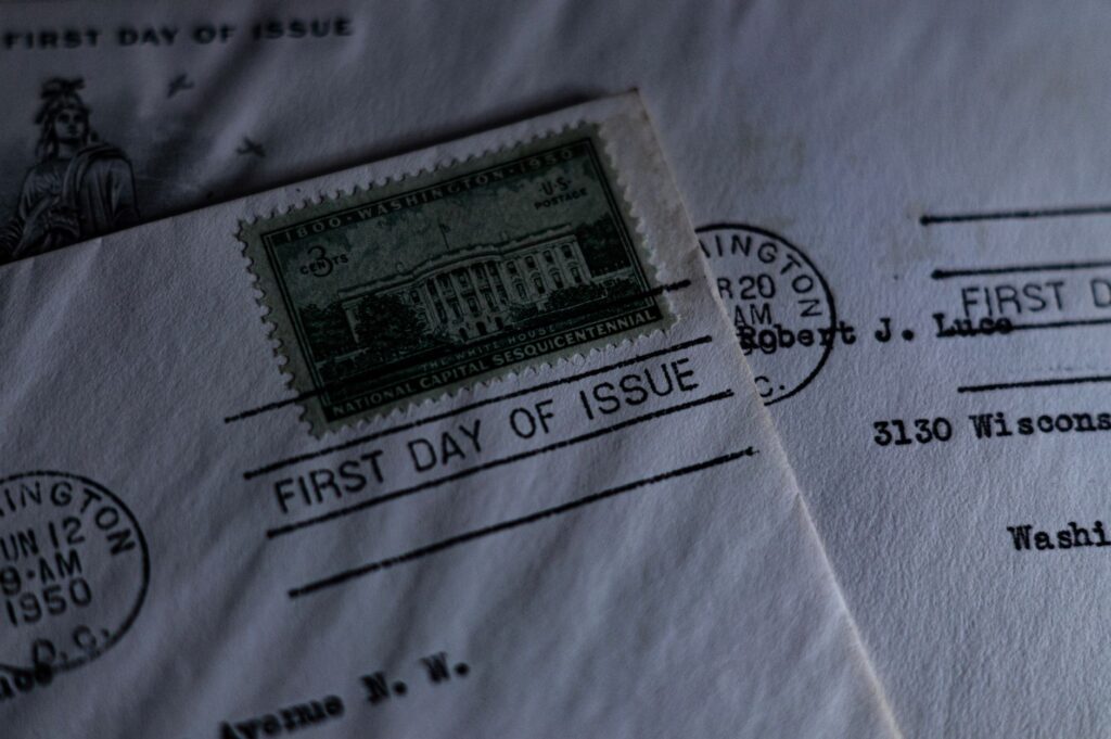 A close-up of a vintage first day of issue postage stamp on an envelope, evoking nostalgia.
