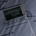 A close-up of a vintage first day of issue postage stamp on an envelope, evoking nostalgia.