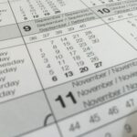 Detailed close-up of a calendar displaying months in several languages.