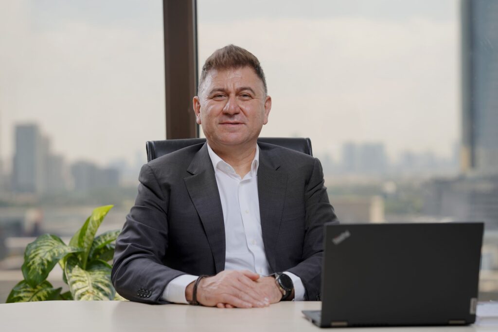 Confident middle-aged businessman in an elegant office with city view.
