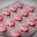 Pink tablets in a blister pack, emphasizing healthcare and medication concepts.