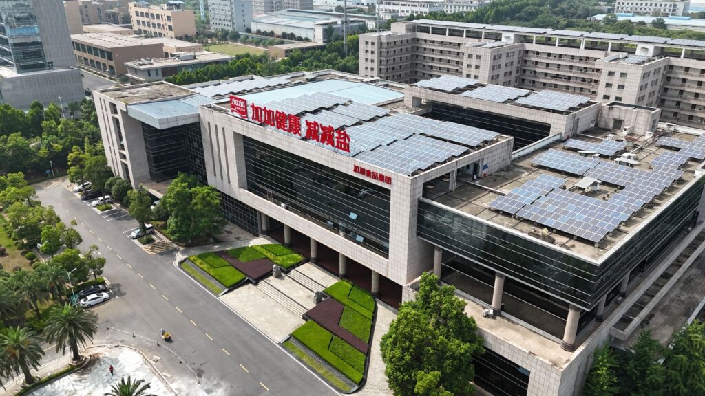 Aerial view of a modern building with solar panels, showcasing sustainable architecture.