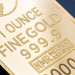 Detailed close-up of a 1 ounce fine gold bar with inscriptions, ideal for finance and investment themes.