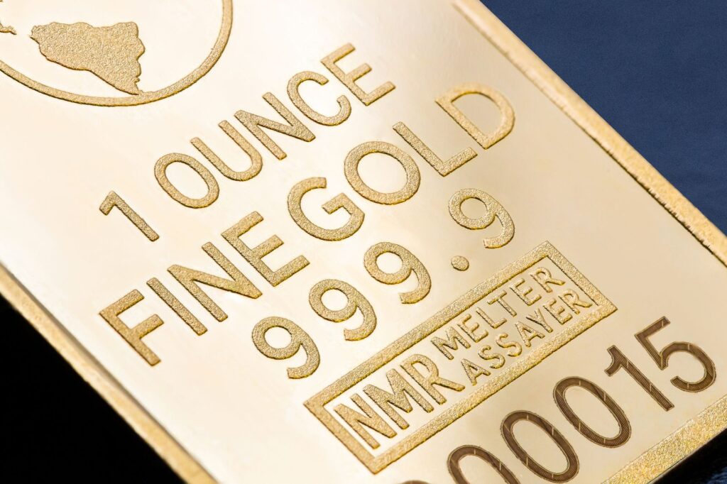 Detailed close-up of a 1 ounce fine gold bar with inscriptions, ideal for finance and investment themes.
