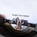 Close-up of a typewriter typing 'Google Core Update' on paper, symbolizing digital advancement.