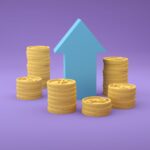 Stacks of coins with an upward arrow symbolizing financial growth and success.