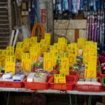 Explore a lively market stall displaying a range of goods with bold sales tags.
