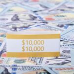 Close-up of US dollar banknotes with a $10,000 money band, ideal for finance and investment themes.