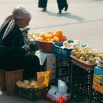 A local vendor selling fresh fruits at an Uzbek street market, showcasing daily life in Uzbekistan.