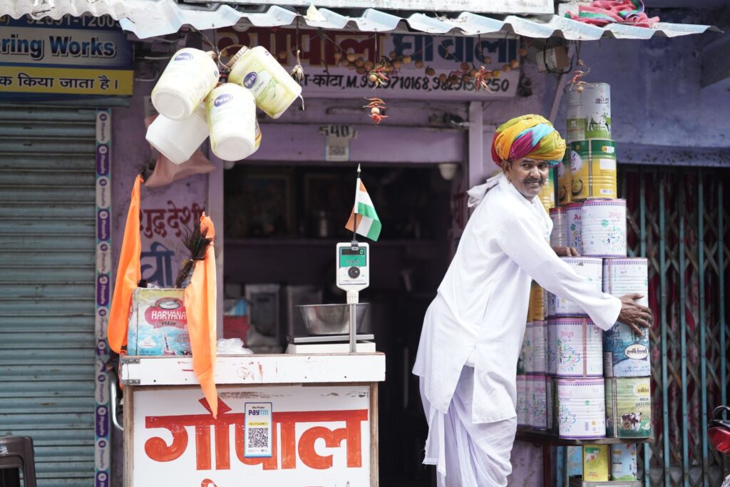 A vibrant Indian merchant arranging products outside his shop in Kota, Rajasthan.
