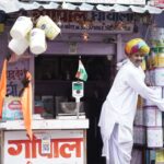 A vibrant Indian merchant arranging products outside his shop in Kota, Rajasthan.