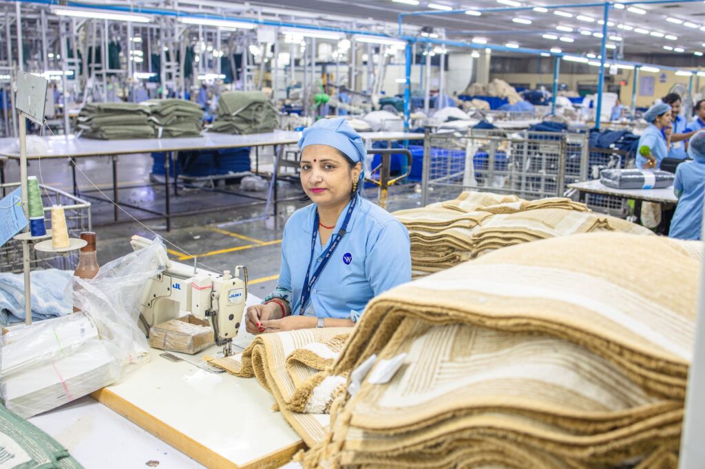 Indian factory worker in textile mill showcasing industrial production process.