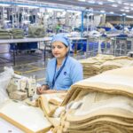 Indian factory worker in textile mill showcasing industrial production process.