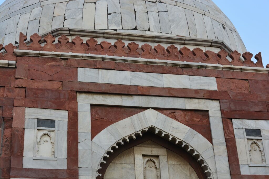 Close-up view of historical architecture from a monument in Delhi, showcasing intricate stonework.