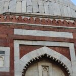 Close-up view of historical architecture from a monument in Delhi, showcasing intricate stonework.
