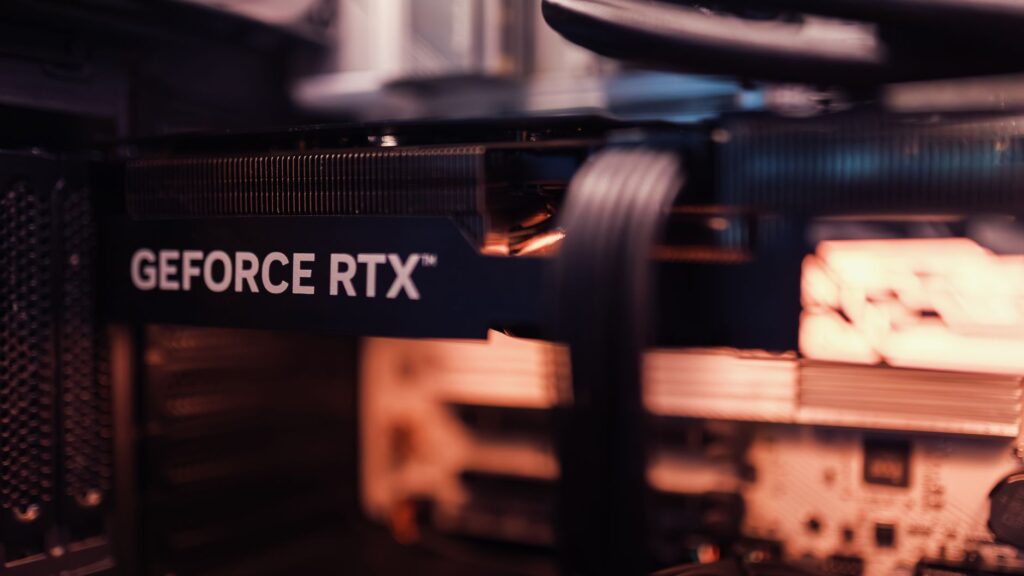 Detailed view of a GeForce RTX graphics card installed in a computer setup, highlighting modern technology.