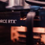Detailed view of a GeForce RTX graphics card installed in a computer setup, highlighting modern technology.