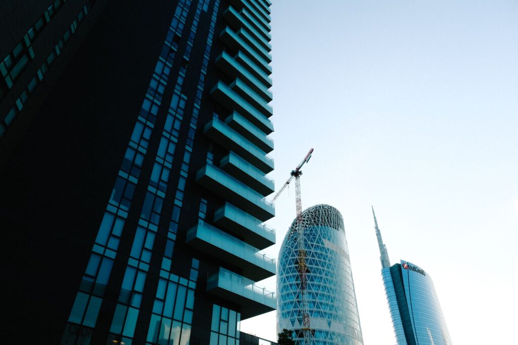 Low angle view of Milan's modern skyline showcasing contemporary skyscrapers and blue glass structures.