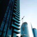 Low angle view of Milan's modern skyline showcasing contemporary skyscrapers and blue glass structures.