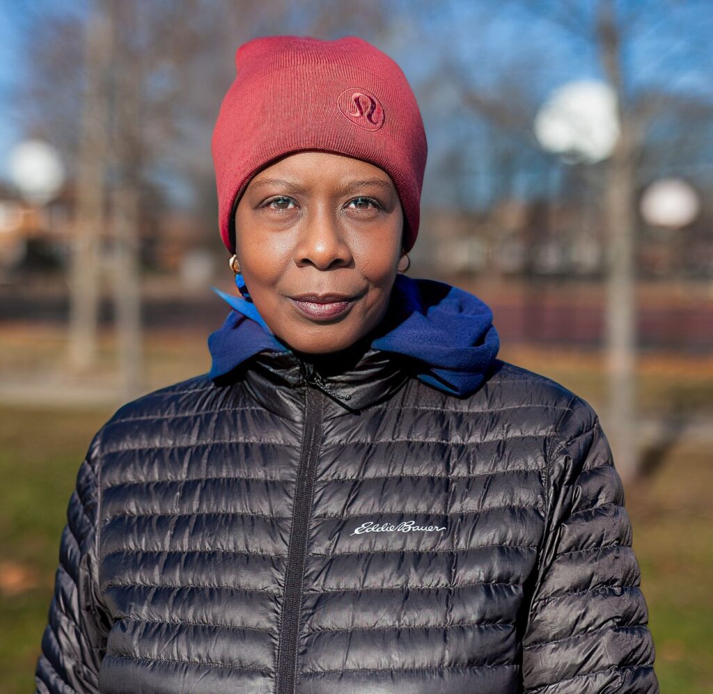 Portrait of a woman in winter attire, Chicago park setting, showcasing fashion.