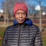 Portrait of a woman in winter attire, Chicago park setting, showcasing fashion.