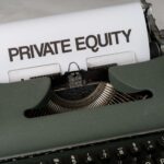 Close-up of vintage typewriter with 'PRIVATE EQUITY' on paper, business concept.