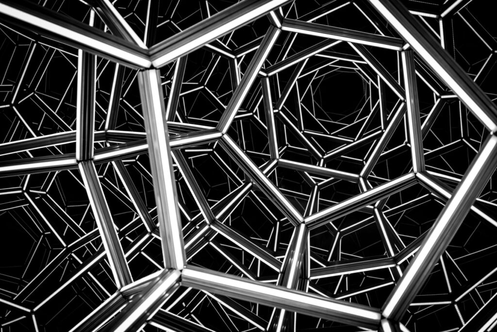 Abstract black and white illustration of a complex geometric metal framework, creating a captivating visual illusion.