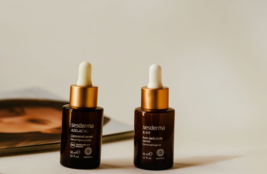 Liposomal and anti-dark circle serums showcased in stylish amber bottles with droppers.