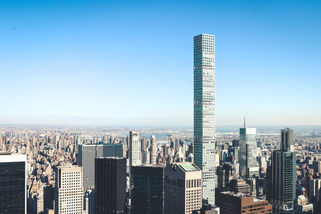 Stunning aerial view of New York City skyline featuring iconic skyscrapers under a clear sky.